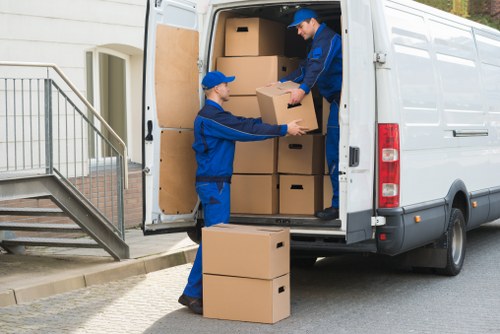Furniture being carefully carried down stairs in a Kennington apartment