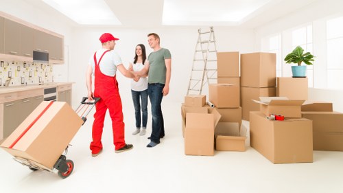 Removal team loading items from a Kennington flat into a van