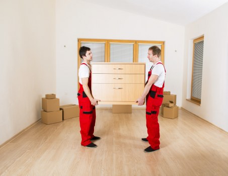 Movers carrying boxes down stairs during a same day removal in Kennington