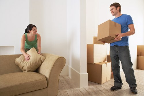 Team member using proper manual handling techniques with a box